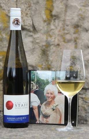 photo of a bottle of Riesling Loved By Lu, a photograph of Lu Staff and a glass of Riesling Loved By Lu