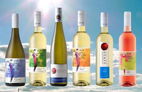 A collage of six wine bottles on top of a photo of a sunny blue sky with clouds